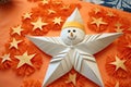 An origami-inspired clown star with a cheerful face surrounded by star decorations on an orange background.