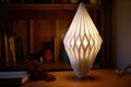 origami lampshade casting cozy light on table