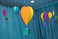 Origami made colorful air balloon cloud. Beautiful colored paper lanterns hanging on the ceiling as air balloons Royalty Free Stock Photo