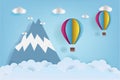 Origami made colorful hot air balloon flying over the mountain with cloud.Paper art style. Royalty Free Stock Photo