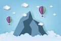 Origami made colorful hot air balloon flying over the mountain with cloud.Paper art style. Royalty Free Stock Photo