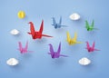 Origami made colorful paper bird flying on blue sky with clound Royalty Free Stock Photo