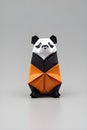 Origami panda on light background