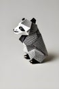 Origami panda on light background