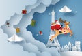 Origami paper art of Santa Claus give presents in town and Eiffel tower Royalty Free Stock Photo