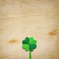 Origami paper green clover shamrock leaf on light plywood background. Royalty Free Stock Photo