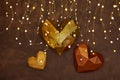 Origami paper hearts geometric on the brown wall with garland