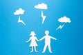 Origami paper man and woman are holding hands under lightning strikes. Safe and insurance family. accident protection. Royalty Free Stock Photo