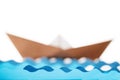 Origami paper ship and water waves on white background Royalty Free Stock Photo