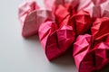 Origami red and pink paper hearts on white background, copy space