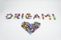 Origami sign and heart creative concept made of bunch of multi colored origami stars