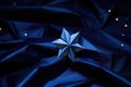 origami star nestled amid dark blue craft paper to mimic night sky