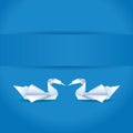 Origami swans on blue background Royalty Free Stock Photo