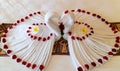 Origami swans made out of towels and laid out on a bed in a honeymoon suite