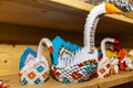 Origami swans and penguins on a shelf