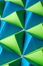Origami tetrahedrons in blue, yellow and green colors. Royalty Free Stock Photo