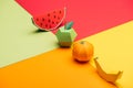 Origami watermelon, apple, tangerine and banana on colorful paper.