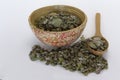 Origanum dictamnus, Dittany of Crete tea in bowl and in wooden spoon on white background. Cretan dittany or hop marjoram