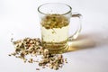 Origanum dictamnus tea in glass cup and on white background