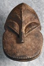 An Original African old tribal mask figure, hand carved from wood. Isolated on gray