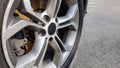 The original alloy wheel, dirty and scratched on the car close-up. Worn car wheels are waiting for repair. selective focus. Car Royalty Free Stock Photo