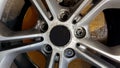 The original alloy wheel, dirty and scratched on the car close-up. Worn car wheels are waiting for repair. selective focus. Car Royalty Free Stock Photo