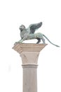 Original ancient top tower sculpture of symbol of Venice winged lion at the Piazza San Marco isolated at white background, Venice