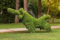 Original animal figure made on a green bush