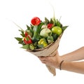 Original beautiful bouquet of vegetables and fruits in the hands of a girl on a white background Royalty Free Stock Photo