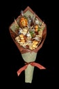 Original bouquet consisting of dried salted fish, salted peanuts, crackers, dried bread and other beer snacks isolated on black ba