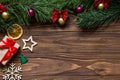 Original Christmas angled exposition with a gift box, snowflake, star, firtree, slice of lemon on the wooden background Royalty Free Stock Photo