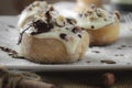 Original cinnabon rolls with chocolate-cream sauce and hazelnuts Royalty Free Stock Photo