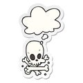 A creative cartoon skull and bones and thought bubble as a printed sticker