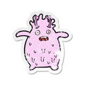 A creative retro distressed sticker of a cartoon funny slime monster