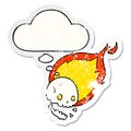 A creative spooky cartoon flaming skull and thought bubble as a distressed worn sticker Royalty Free Stock Photo