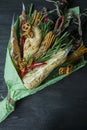 Original edible gift in the form of a bouquet consisting of beer, sausages, cheese, beer snacks. Girl holds edible bouquet in her