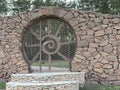 The original entrance door to the courtyard. A metal door in a fence wall. Entrance from the street, the exterior of the land