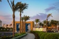 Original facade of a hotel complex with large palm trees in Port Ghalib, Marsa Alam, Egypt Royalty Free Stock Photo