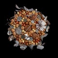 Original gift homemade in the form of a bouquet of different varieties of nuts and decorated with silver leaves isolated on black