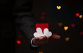 Man hand holds box and hearts made of paper Royalty Free Stock Photo