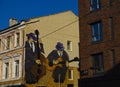 Original graphic design on the wall of an old brick house. Drawing of two musicians playing on the wall.