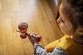 Little girl plays with the kendama