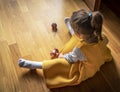 Little girl plays with the kendama