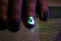 The original manicure in the form of a radioactive danger sign with gel shellac varnish, glows in the dark with