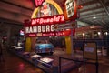 The original Mcdonalds shop sign with one golden arch and 1956 Chevrolet Bel Air