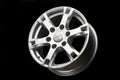 Original Mitsubishi aluminum wheel, from a Japanese SUV on a black background