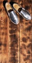 Original shiny shoes in disco style lie on a vintage wooden surface made from fried brown boards. Fashionable clothing retro acce