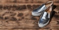 Original shiny shoes in disco style lie on a vintage wooden surface made from fried brown boards. Fashionable clothing retro acce