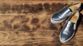 Original shiny shoes in disco style lie on a vintage wooden surface made from fried brown boards. Fashionable clothing retro acce