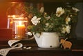 An original still life of Russia with the fire of a wax candle. A rustic still life with white flowers and a burning candle, a sti